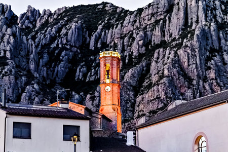 Views of the illuminated Church of Sant Corneli in Collbato, Barcelona at dusk, with the Montserrat...