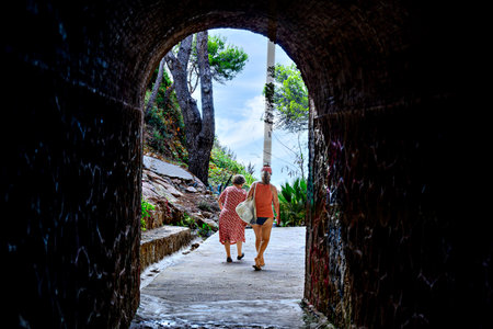Mother and daughter passing through a tunnel on the way to the beachの写真素材