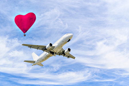 Passenger plane landing at the airport, under a blue sky with white cloudsの写真素材