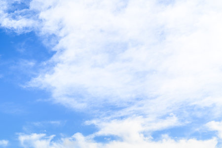 Blue sky background with tiny clouds. Nature background. White cloud on blue sky.の写真素材