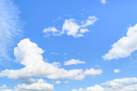 Blue sky background with tiny clouds. The vast blue sky and clouds sky on sunny day. White fluffy clouds in the blue sky.の写真素材