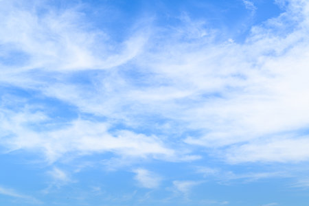 Blue sky background with tiny clouds. The vast blue sky and clouds sky on sunny day.の写真素材
