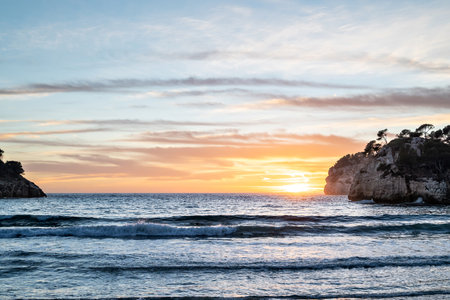 Beautiful sunset views to the horizon from Cala Galdana de Ferrerias, Menorcaの写真素材
