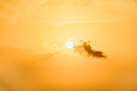 Beautiful orange sunrise sky over the sea horizon. Summer golden hour.の写真素材