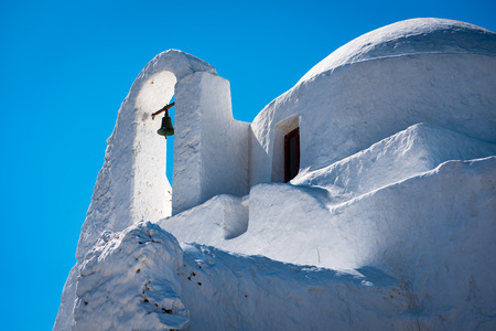 Detail of church on Mykonos with bell and small domeの写真素材