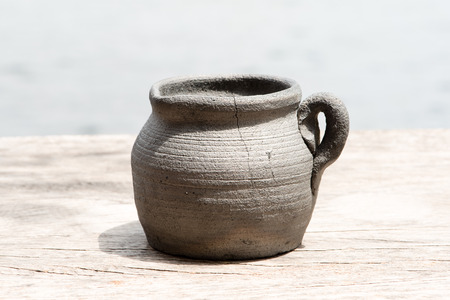 Chinese clay pot on wooden table in natural lightの写真素材