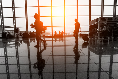 Travelers walk through an airport terminalのeditorial素材