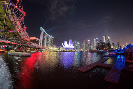 Central Business District of Singapore taken during night. this photo has a bit noise because taken in low light.,SINGAPORE - 29 JUIY 2017: View of Singapore skyline at night with Helix bridge, Hotel Marina Bay Sands and art science museum during Spectra のeditorial素材