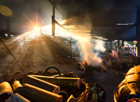 Workers are doing Lam sticky rice in bamboo tubeのeditorial素材