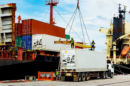 container ship in import export and business logistic.By crane , Trade Port , Shipping.Tugboat...