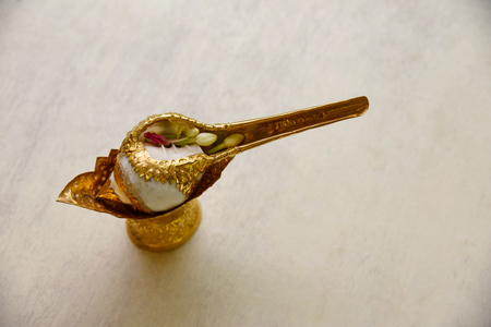 Conch shell and gold bowl for blessing ceremony in weddingの写真素材