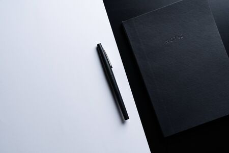 Black style set: notepad and pen on Black background.