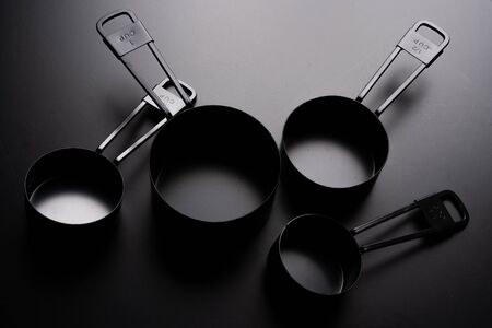 A set of black measuring cup on black background.の写真素材