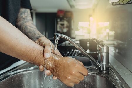 A man washing his hands with foam hand wahs for corona virus prevention, hygiene to stop spreading...