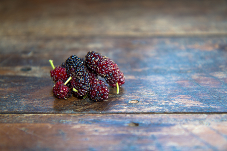 Ripe mulberry on wooden on the table and Natural lightの写真素材