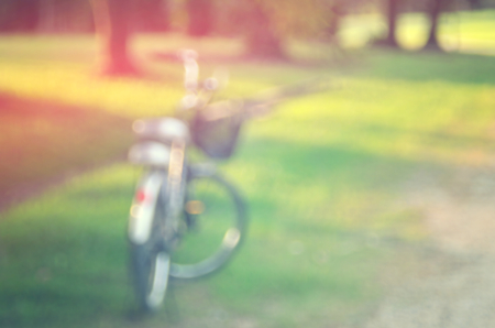Blur vintage bicycle in green nature park abstract background.の写真素材
