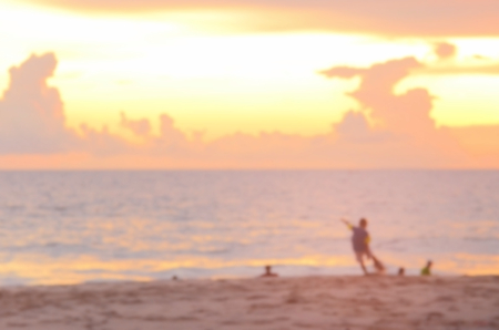 Blur boys playing football on beach and twilight sky abstract background.の写真素材
