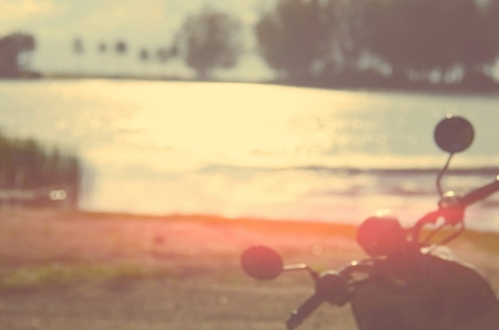 Blur motorcycle on sunset beach abstract background.Travel concept.Vintage color style.の写真素材