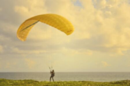 Blur parachute boat on tropical sunset beach abstract background.Travel concept.の写真素材