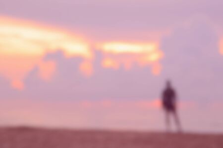 Blur man on tropical sunset beach abstract background.Retro color style.の写真素材