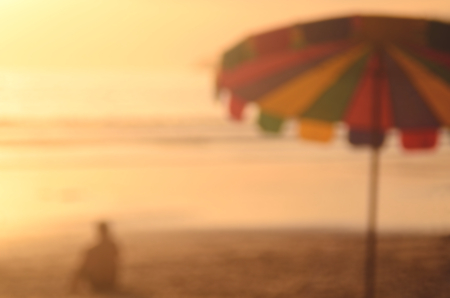Blur umbrella on tropical sunset beach abstract background.Travel concept.の写真素材