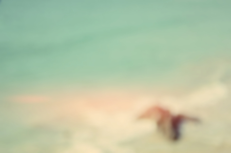 Blur tropical beach with bokeh wave abstract background.Retro color style.の写真素材