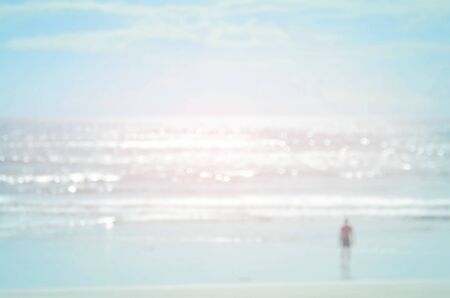Blur man on beach with bokeh wave abstract background.Vintage color style.の写真素材