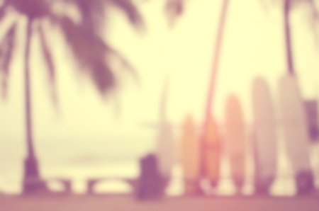 Blur surfboard on tropical sunset beach with palm tree abstract background.Retro color style.の写真素材