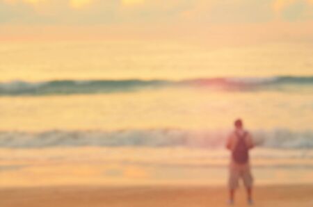 Blur man on tropical sunset beach abstract background.Retro color style.の写真素材