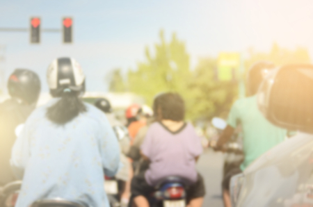 Blur people ride motorbike on traffic road abstract background.Retro color style.の写真素材
