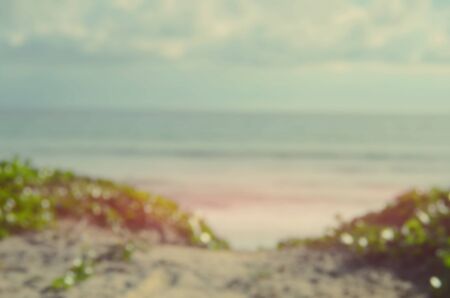 Blur walking way to tropical sunset beach abstract background.Retro color style.
