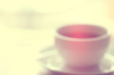 Blur a cup of coffee on table in coffee shop abstract background.Retro color style.の写真素材
