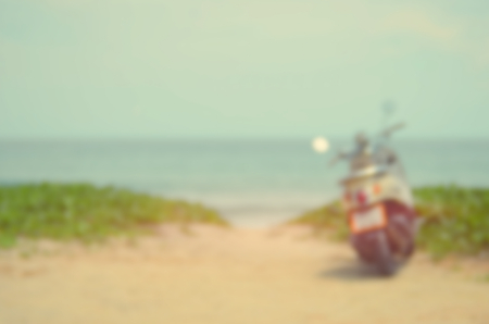 Blur motorcycle on sunset beach abstract background.Travel concept.Vintage color style.の写真素材
