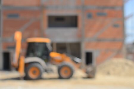 Blur construction site building incomplete and tractor abstract background.の写真素材