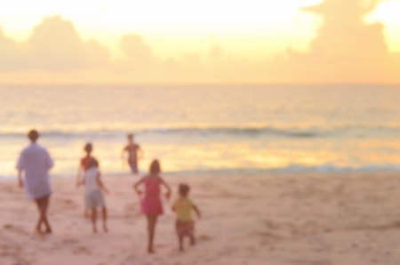 Blurred kid playing on beach abstract background.の写真素材