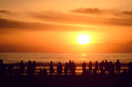 Blur people relax on tropical sunset beach abstract background.の写真素材