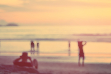 Blur people relax on tropical sunset beach abstract background.Travel concept.Retro color style.の写真素材