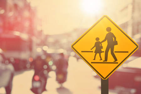 School sign.Traffic sign road on blur road abstract background.Retro color style.の写真素材