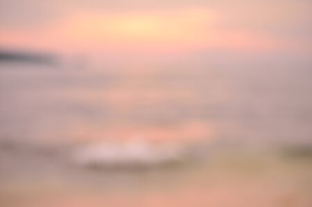 Blur tropical sunset beach with bokeh sun light wave abstract background.Travel concept.の写真素材