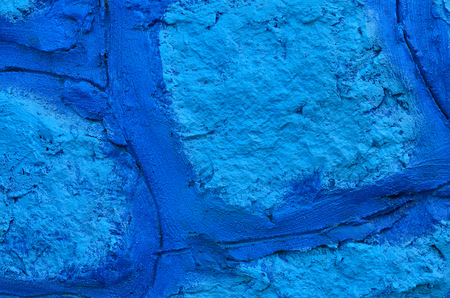 Close up blue paint on stone wall texture background.の写真素材