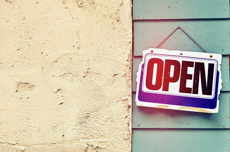 Old open sign hanging on wood background.Retro color style.の写真素材