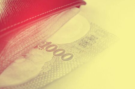 Close up a lot of money in wallet. Retro color style.の写真素材