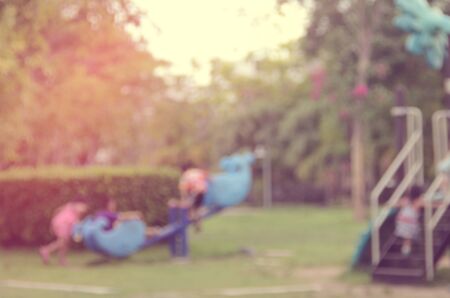 Blur kids playing playground in park abstract background.Retro color style.の写真素材