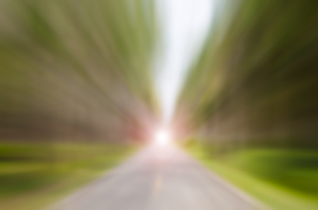 Motion blur country road with nature green forest and blue sky abstract background. Travel concept.