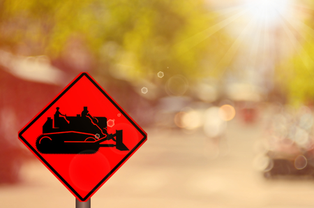 Traffic sign,construction tractor sign on blur traffic road abstract background.Retro color style.の写真素材