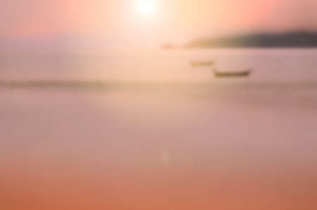 Blur tropical sunset beach with bokeh sun light wave abstract background. Travel concept. Retro color style.の写真素材