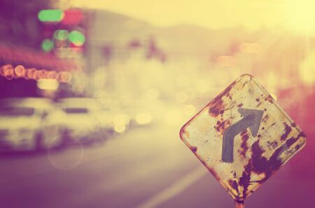 Traffic sign,old curve road sign on blur traffic road abstract background.Retro color style.の写真素材
