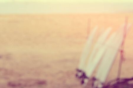 Blur surfboard and palm leaf on tropical beach abstract background. Travel concept. Retro color style.の写真素材