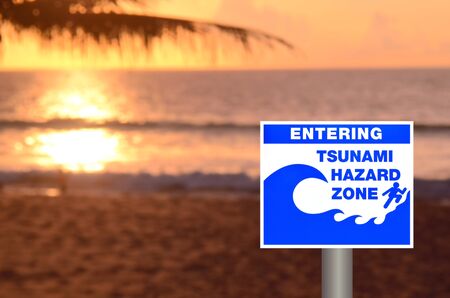 Tsunami sign on blur sunset beach background.の写真素材