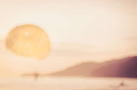 Blur people playing parachute boat on tropical beach abstract background. Travel background concept....